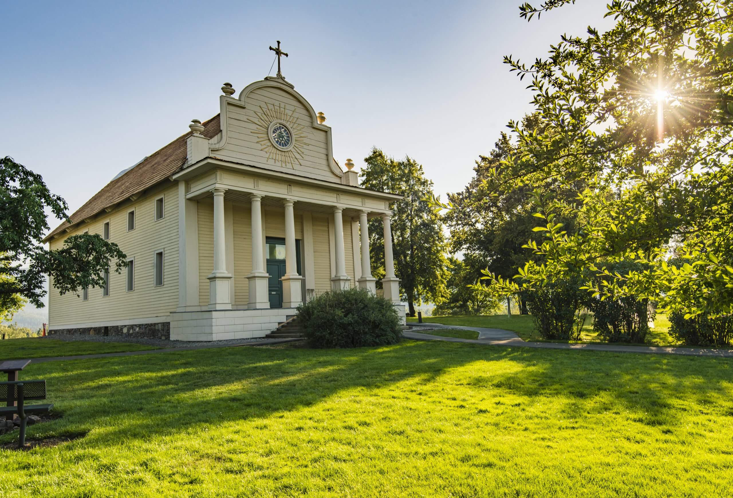 cataldo mission at golden hour, surrounded by grass and trees