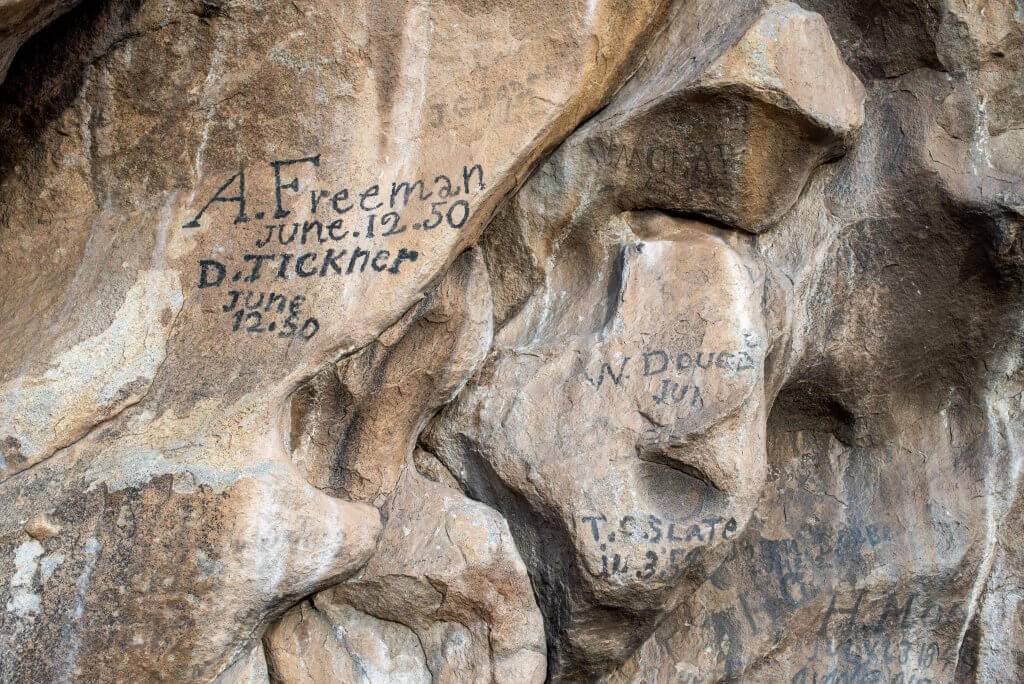 close up shot of names and dates on historical Register Rock in City of Rocks