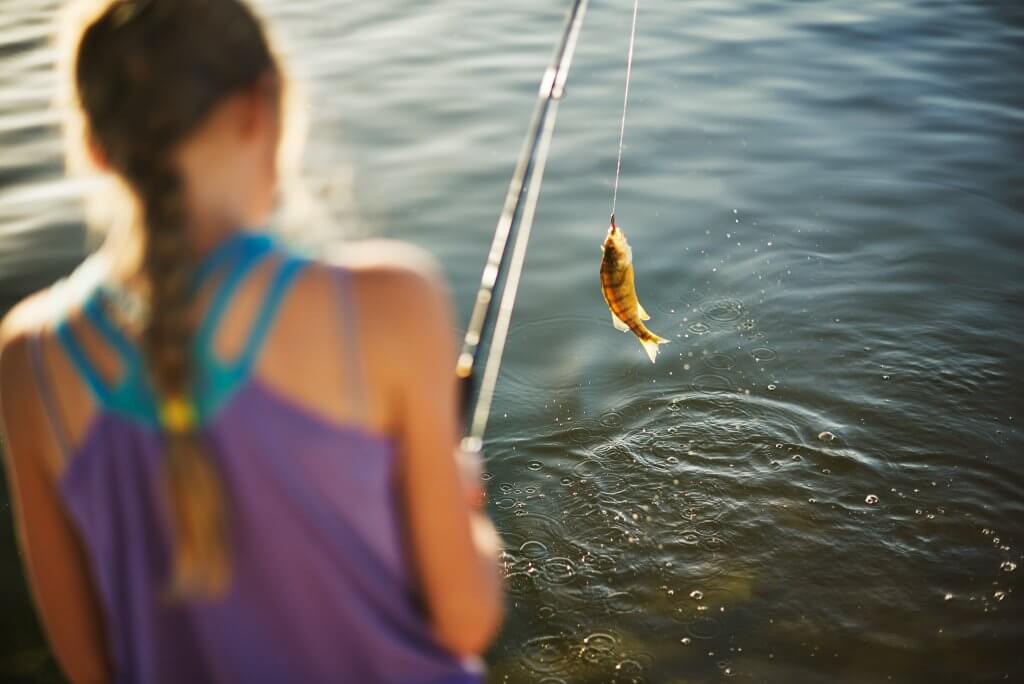 A girl reeling in a fish at the CJ Strike Reservoir.