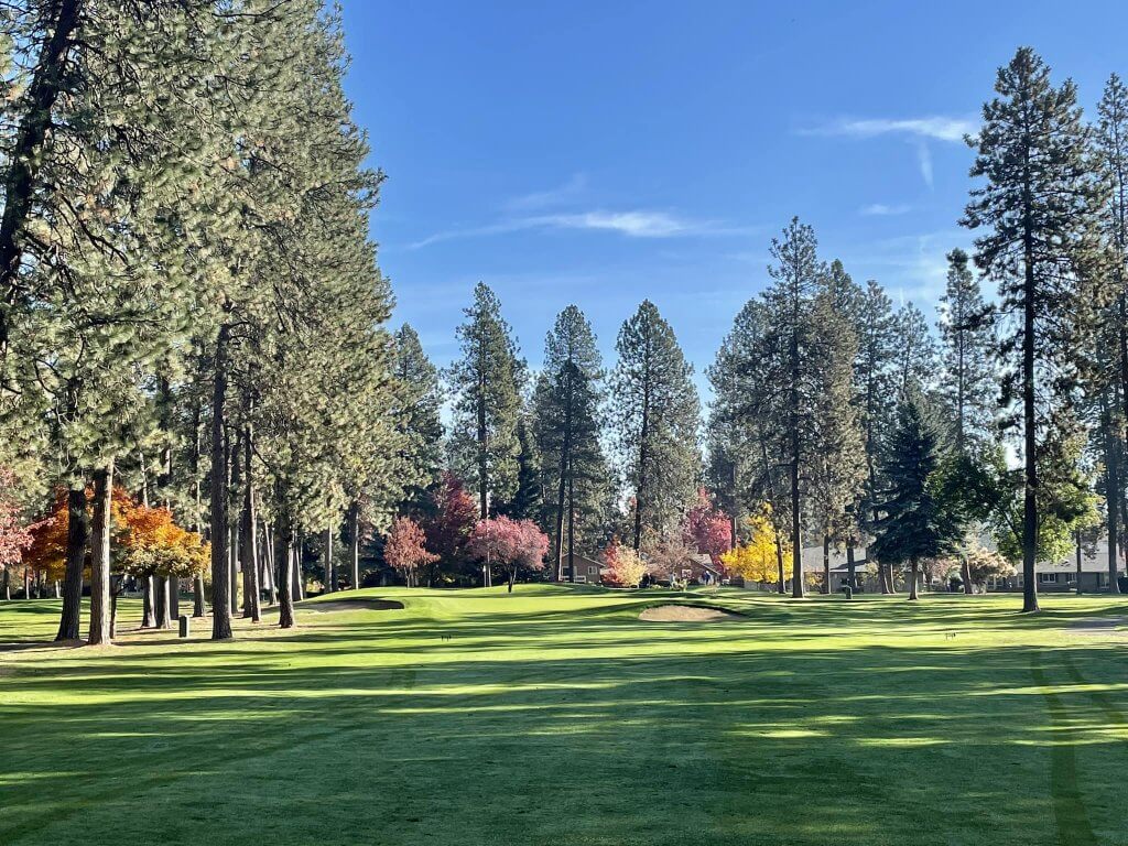 A down range view of the grass and trees on a hole of the Coeur d'Alene Golf Club course.