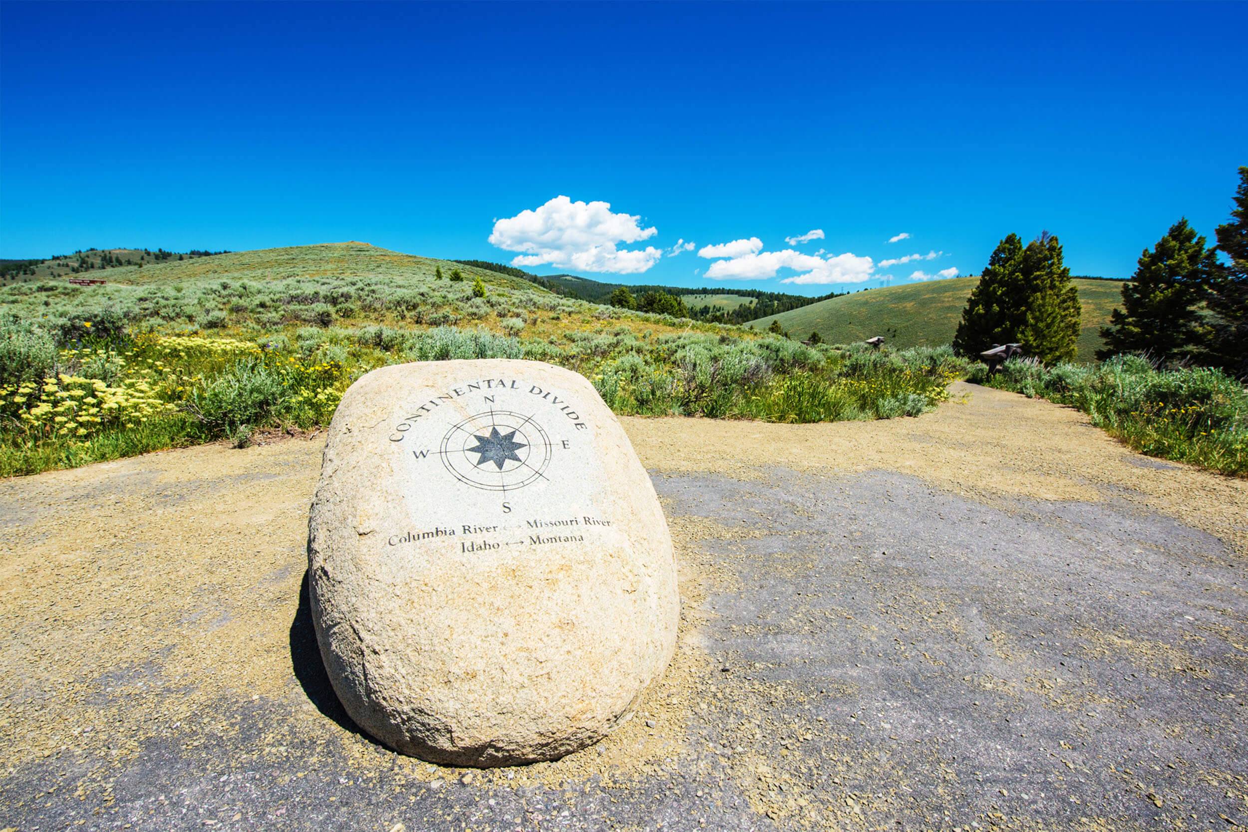 The Continental Divide Trail Marker in front of a Lemhi landscape