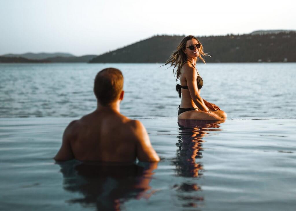 man and woman in infinity pool