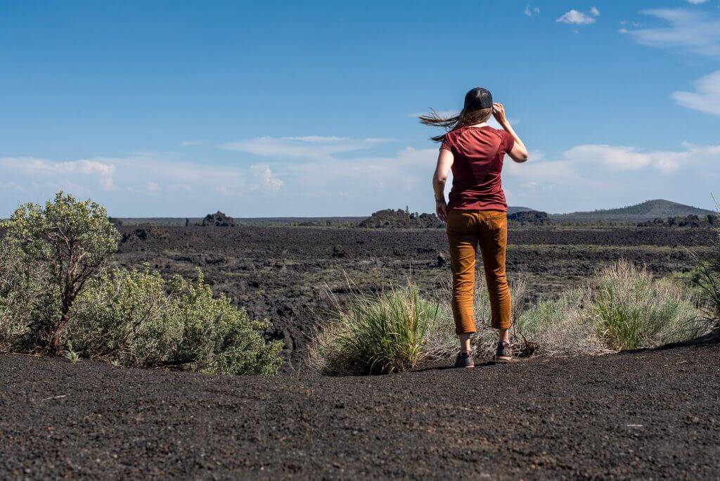 woman overlooking lava field at craters of the moon