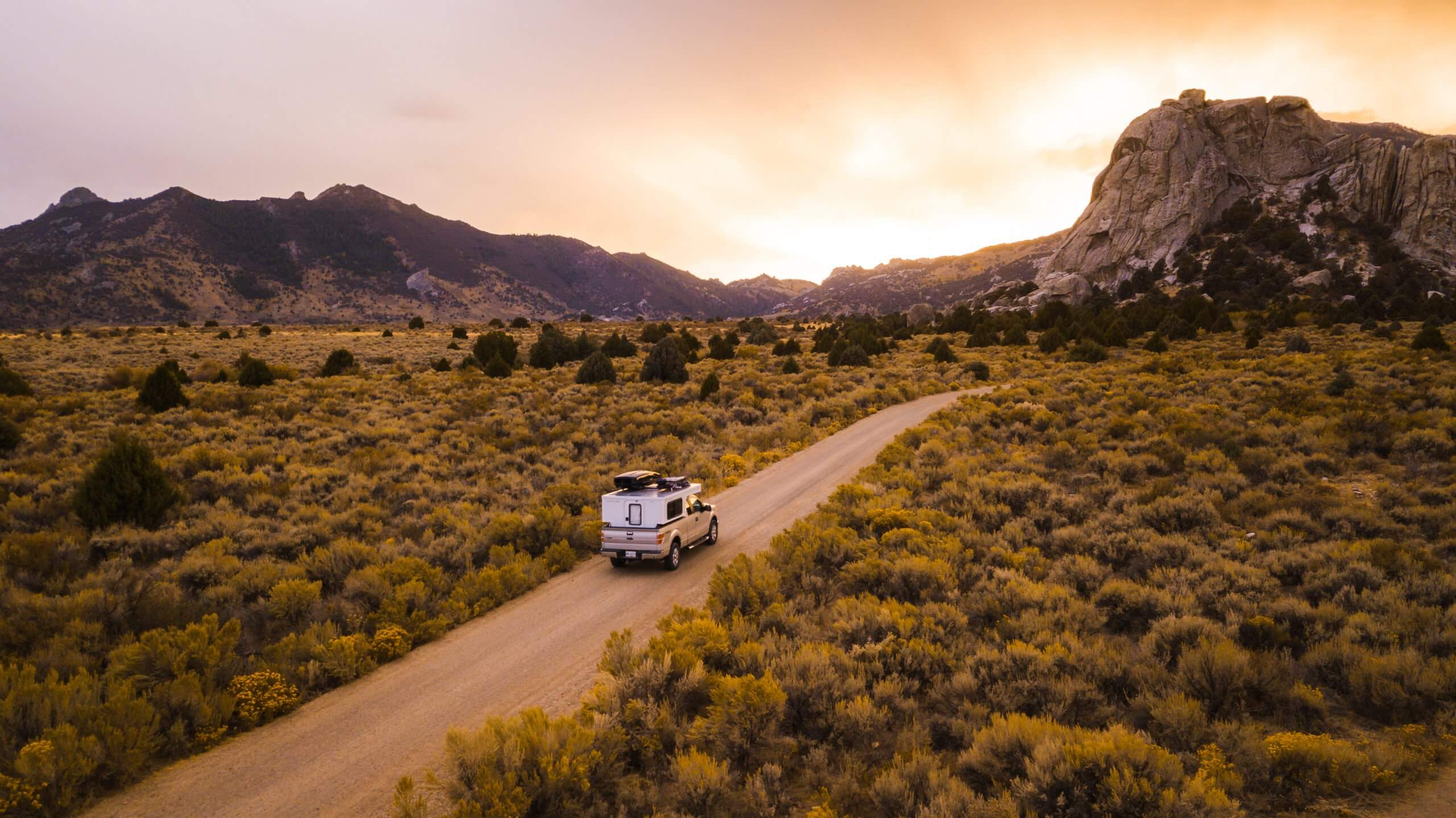 An RV driving on a dirt road to Castle Rocks in Castle Rocks State Park.