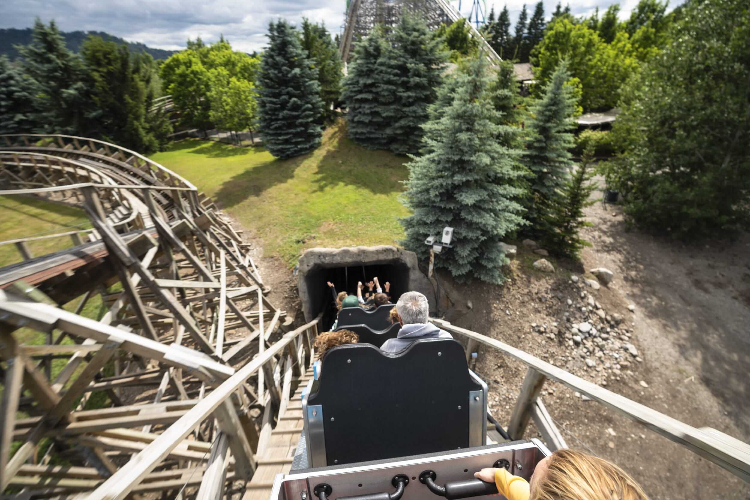 Visitors riding a wooden roller coaster at Silverwood Theme Park