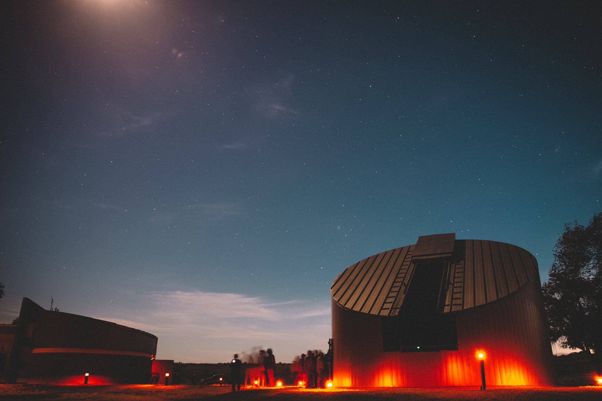 Bruneau Dunes State Park Observatory, at night, surrounded by red glowing lights.
