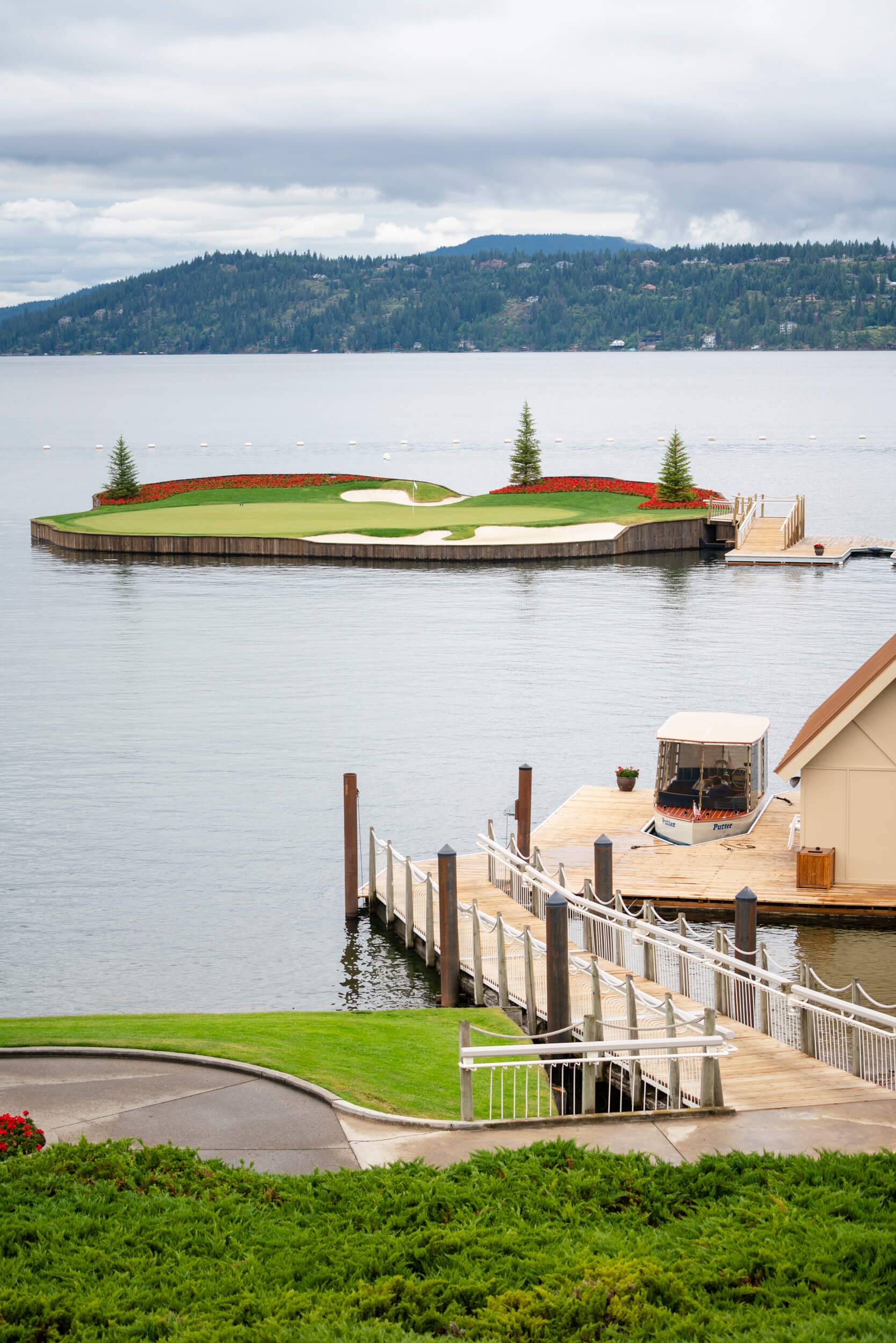 a small portion of a golf course floats in a lake