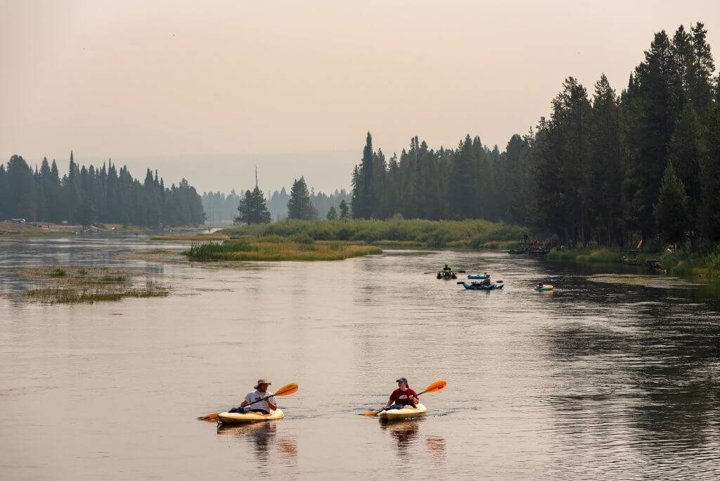 people kayaking down river