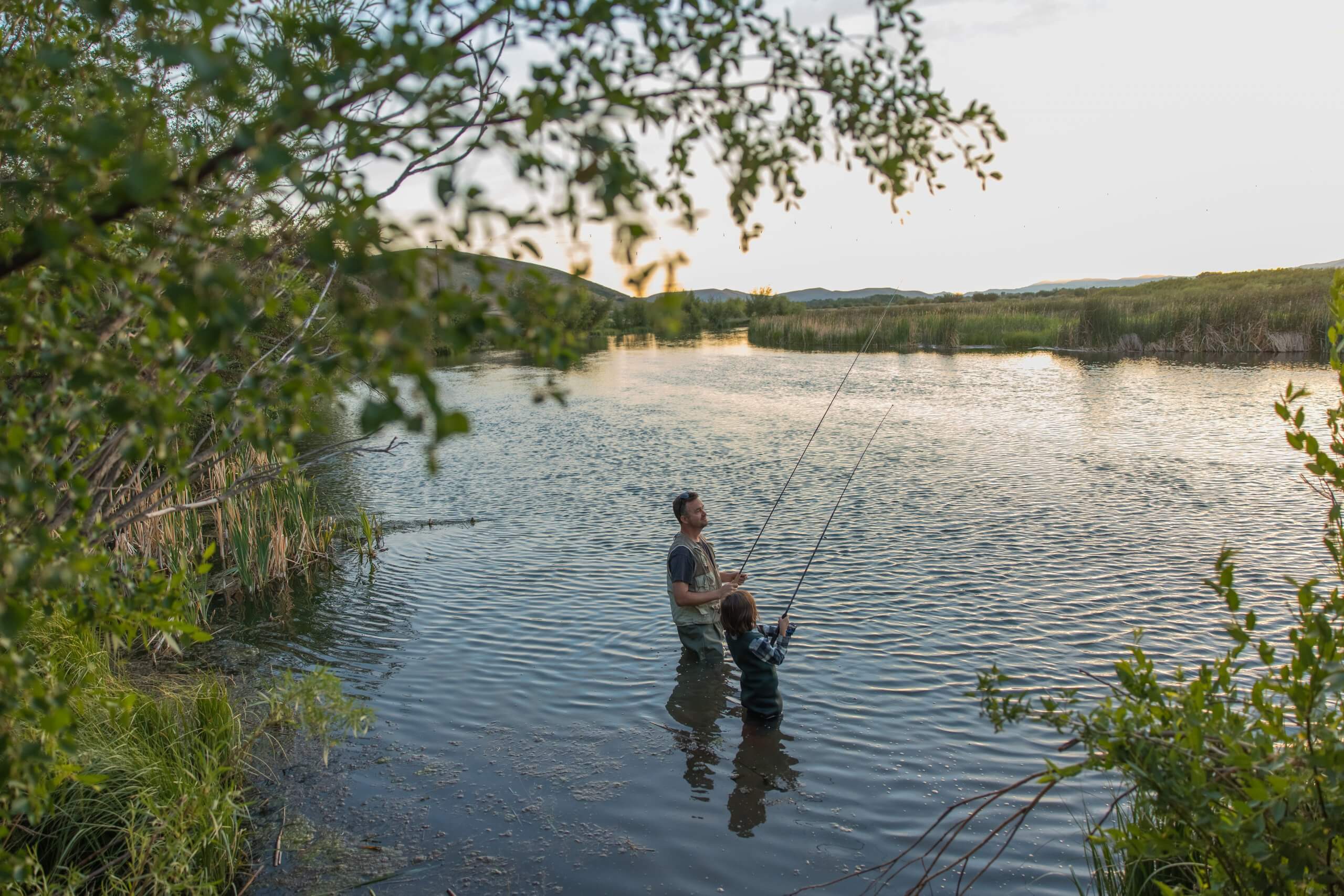 A father and child fishing together at Silver Creek Preserve