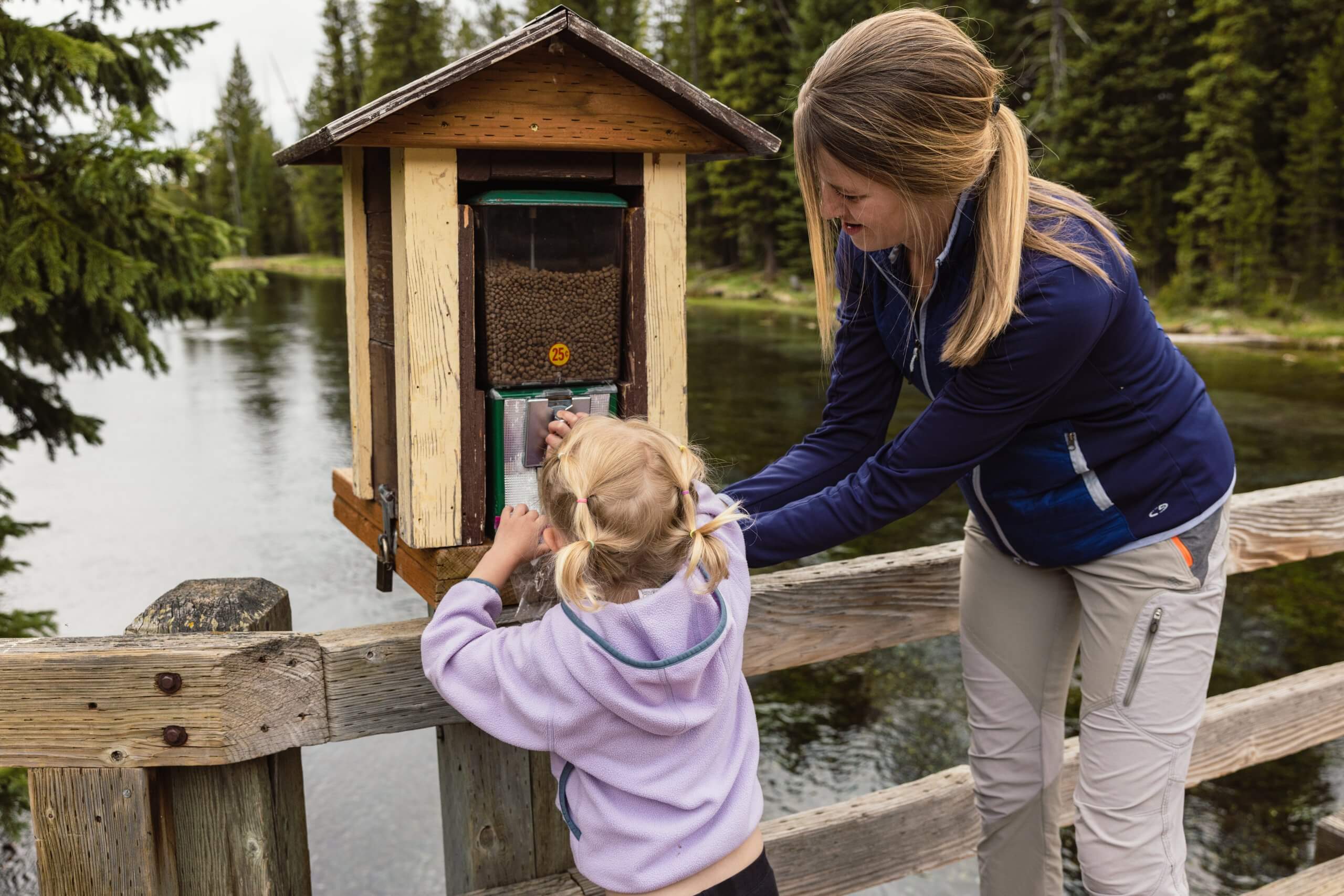 A woman and her daughter buy fish food from a dispenser at Big Springs.