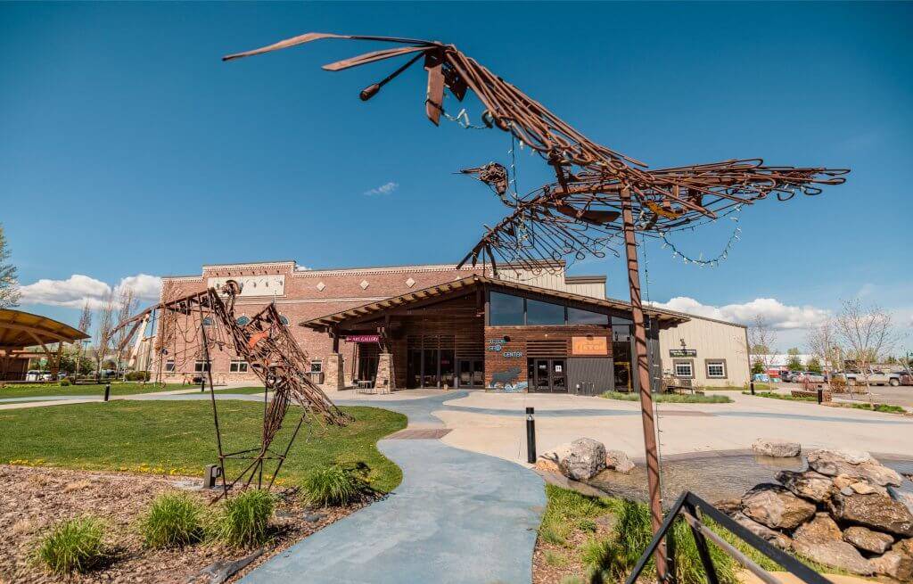 Exterior view of the Teton Geo Center with metal bird sculptures in the foreground.