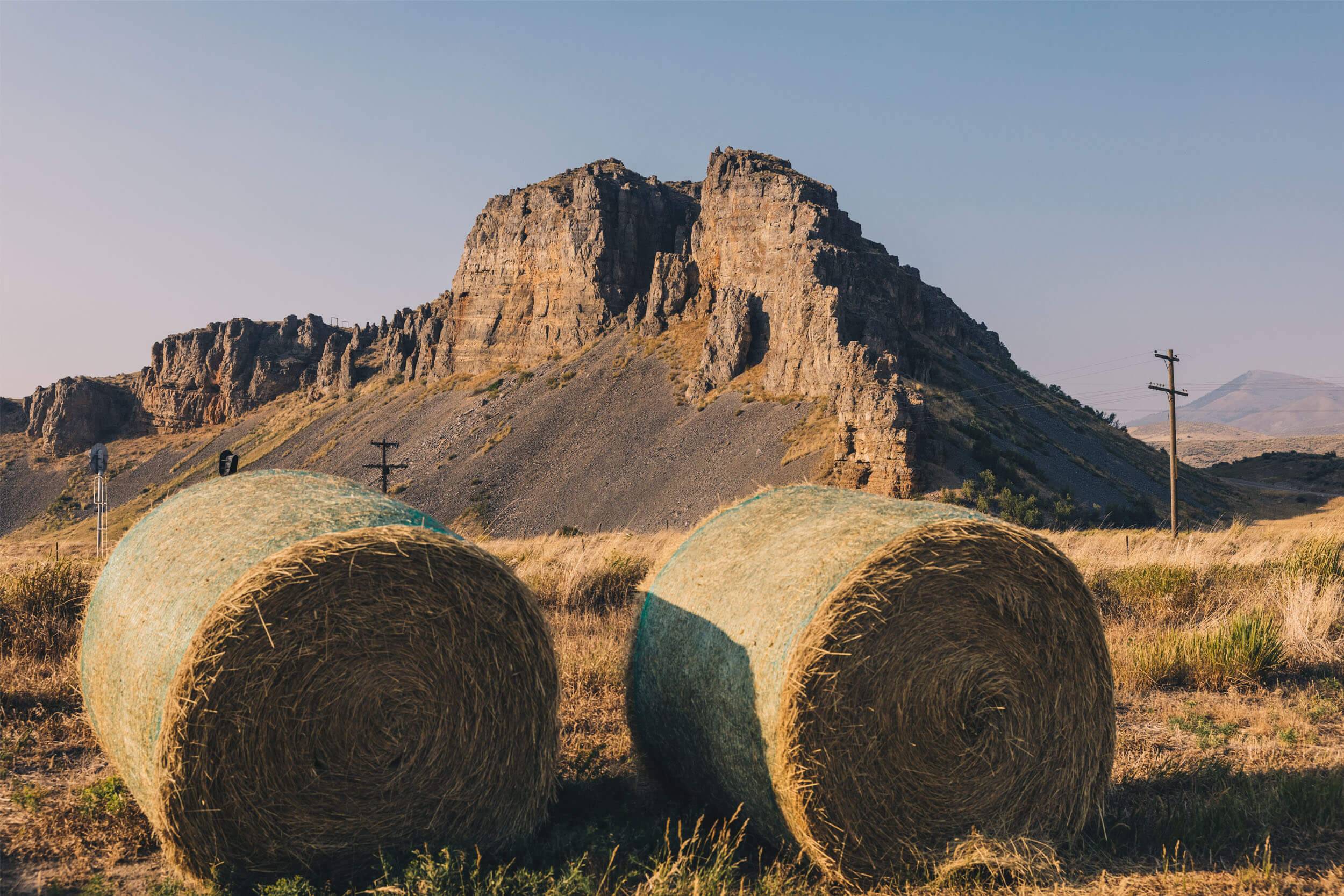 close up of two bales of hay, with Red Rock Pass in the backround