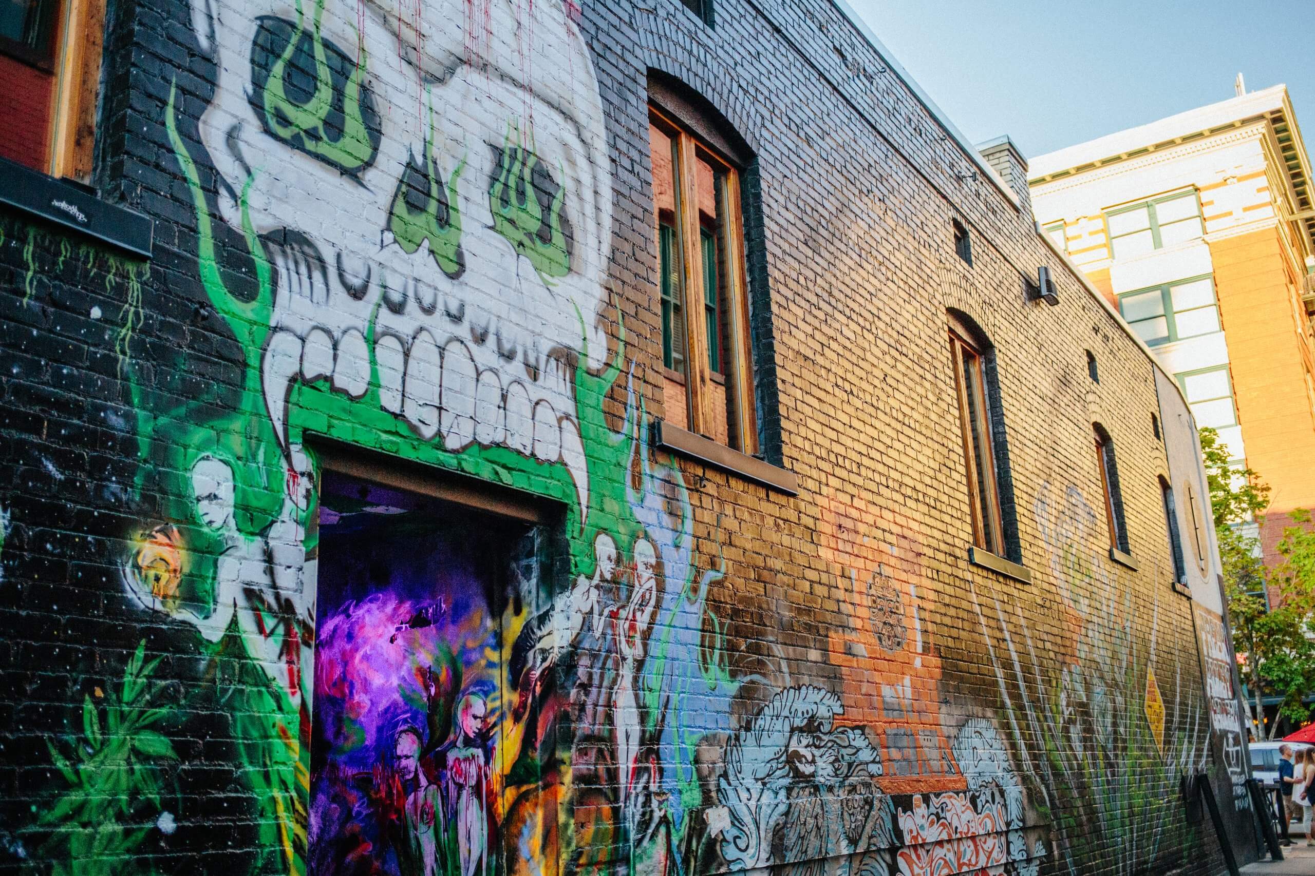 artistic graffiti on a brick wall in Freak Alley