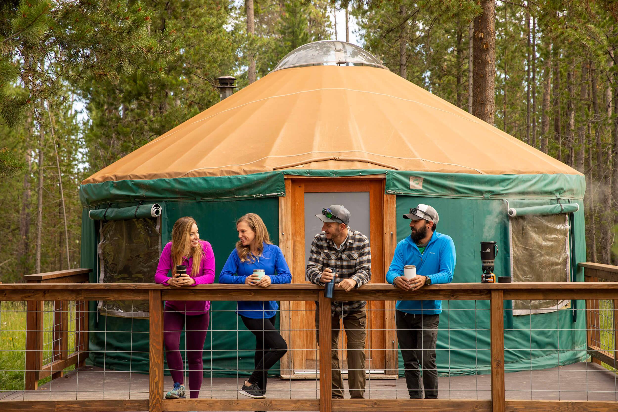 friends standing in front of a yurt