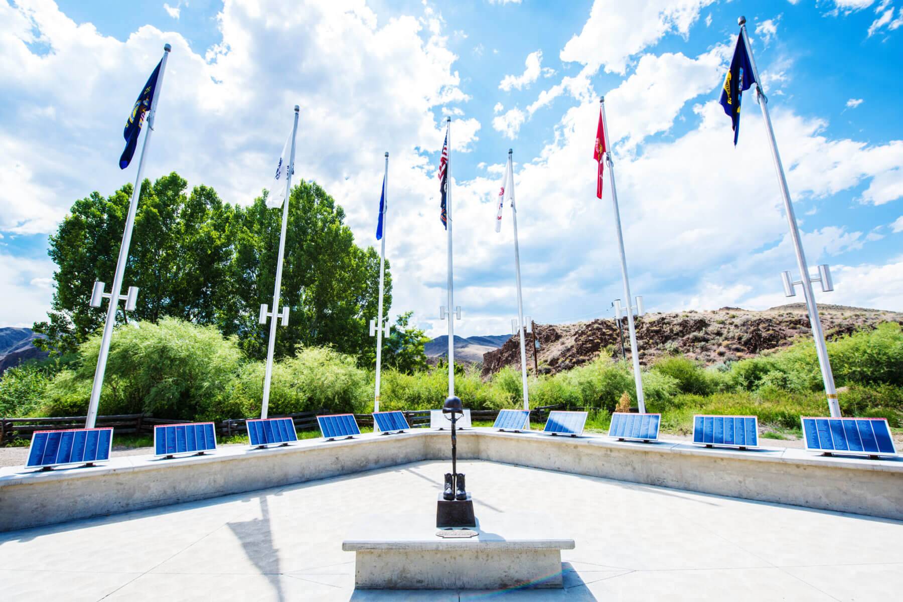 Front view of the Veterans of Custer County Memorial with seven raised flags.