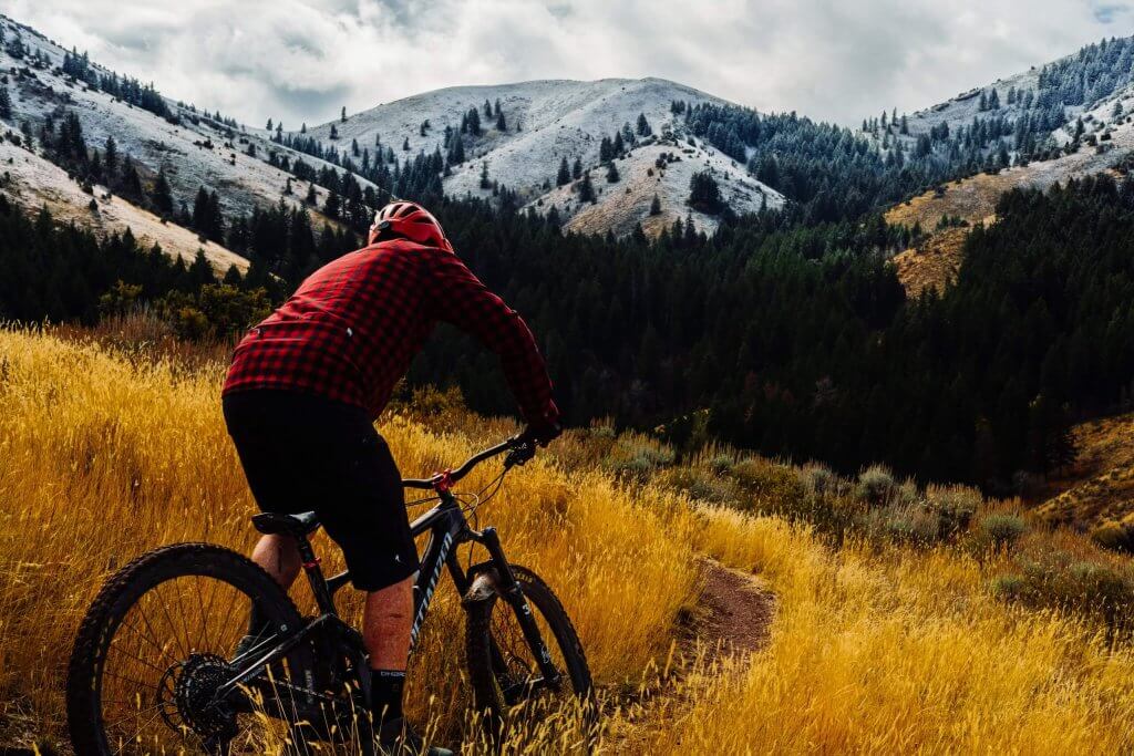 Man climbs Gibson Jack Loop on mountain bike outside Pocatello Idaho.