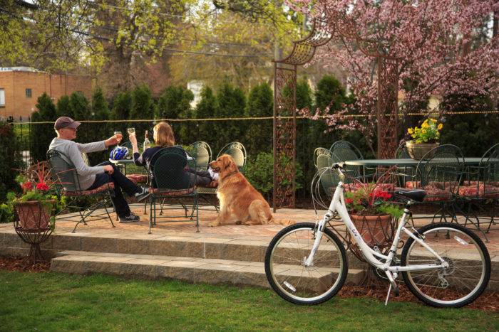 man and woman on patio with dog