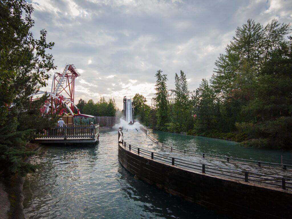 Wide shot of Silverwood Theme Park with rollercoaster track and Roaring Creek Log Flume.