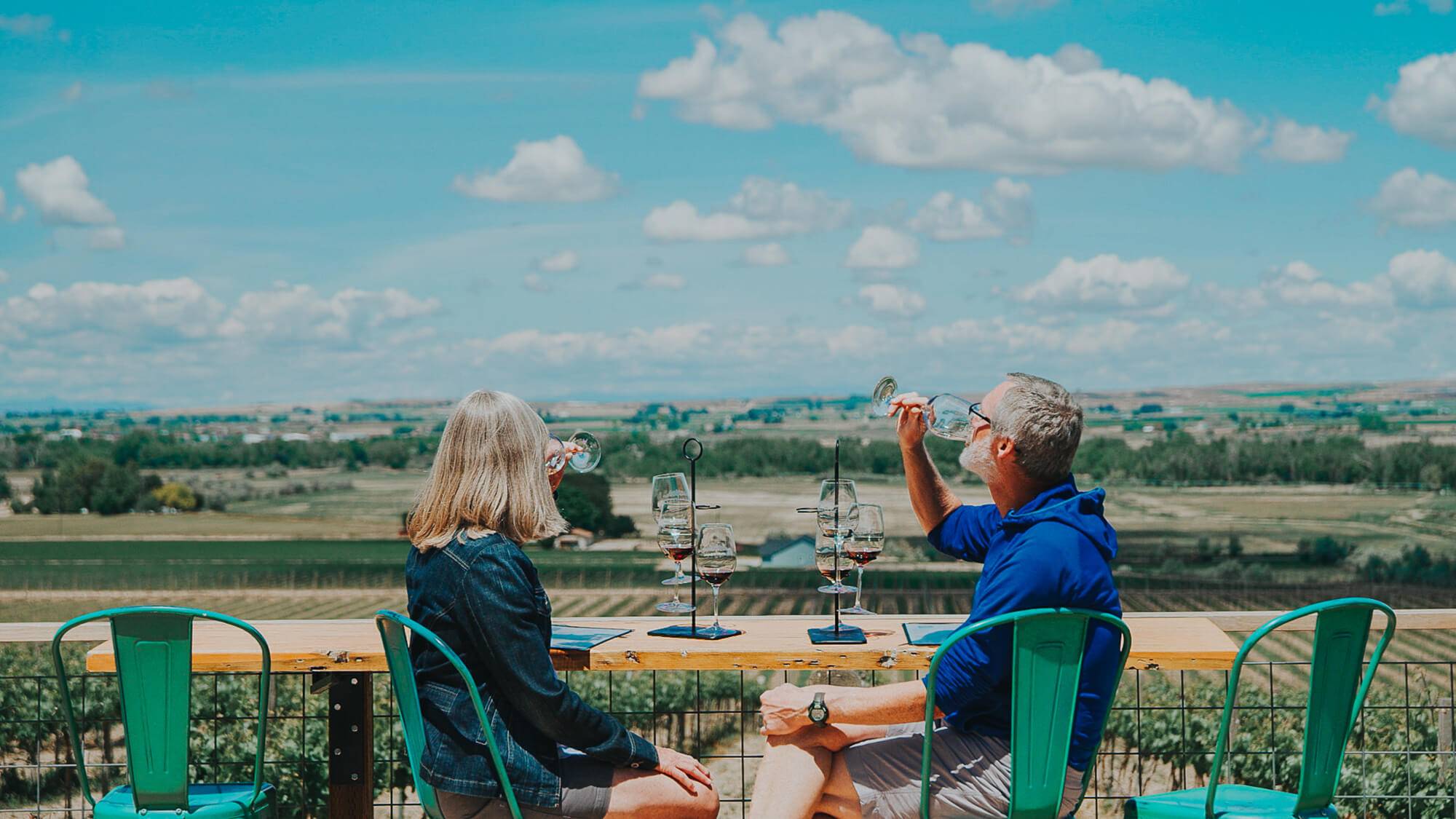 A couple enjoys a wine tasting overlooking the Parma Ridge Winery.