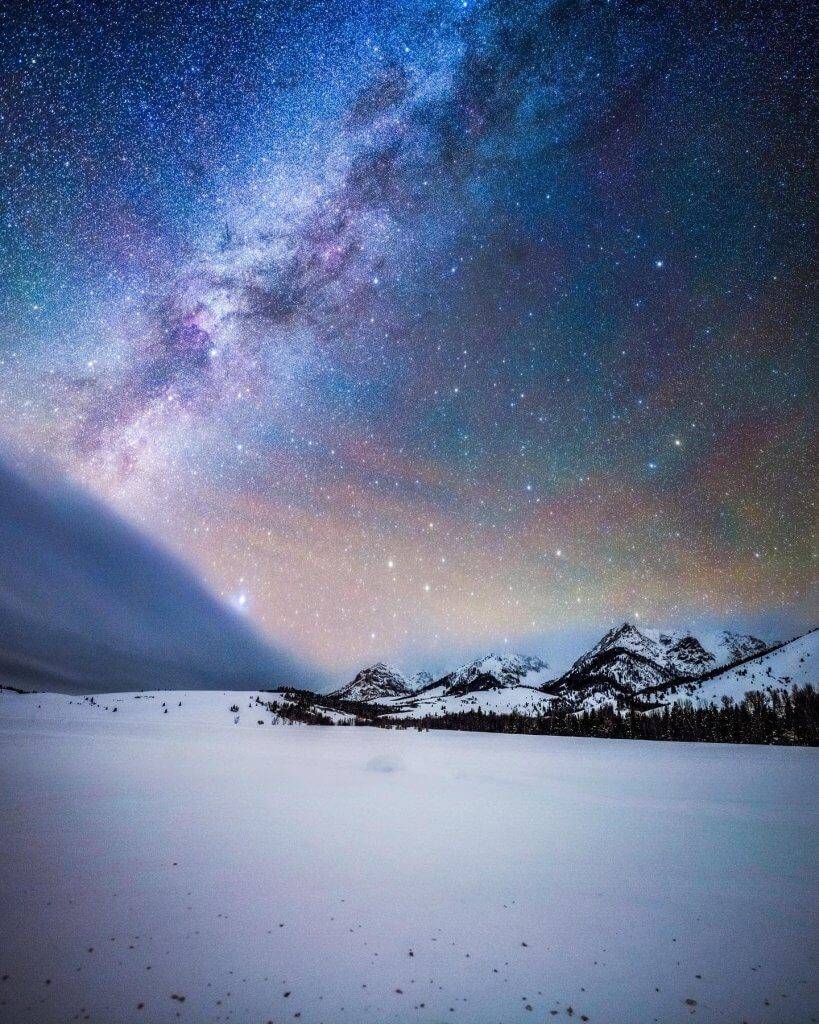 stars over snow covered mountains