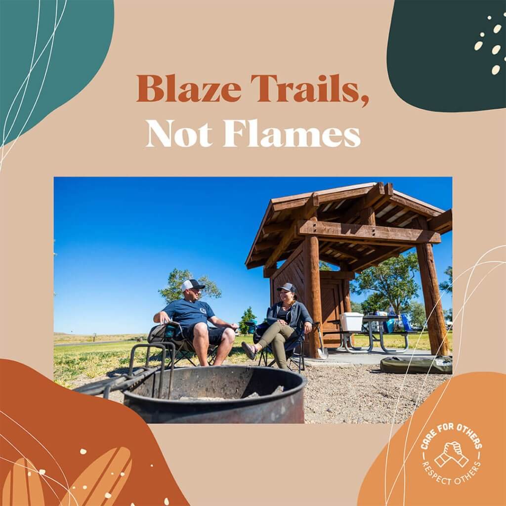 An illustrated card showing the words, "Blaze Trails, Not Flames" above an image of two people sitting in chairs in front of a fire pit at a campsite at Bruneau Dunes State Park.