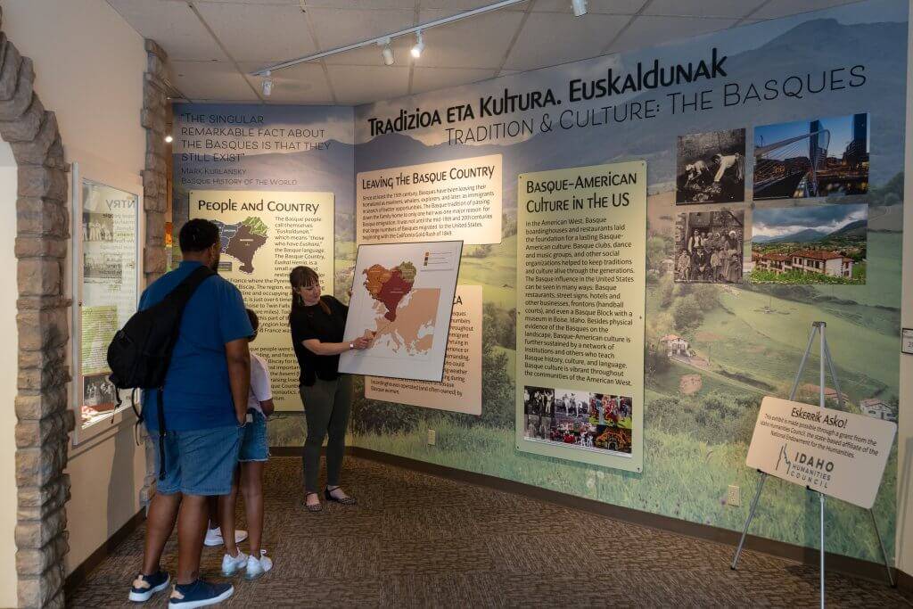 dad and two children looking at exhibit about Basque culture in Idaho
